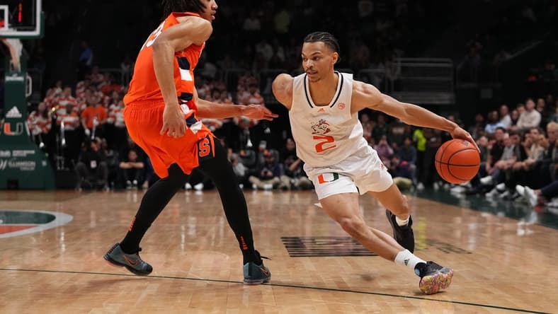 Jan 16, 2023; Coral Gables, Florida, USA; Miami Hurricanes guard Isaiah Wong (2) drives the ball around Syracuse Orange forward Benny Williams (13) during the second half at Watsco Center. Mandatory Credit: Jasen Vinlove-USA TODAY Sports
