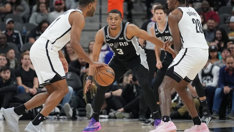 Jan 17, 2023; San Antonio, Texas, USA; San Antonio Spurs forward Keldon Johnson (3) defends Brooklyn Nets forward T.J. Warren (1) in the first half at the AT&T Center. Mandatory Credit: Daniel Dunn-USA TODAY Sports