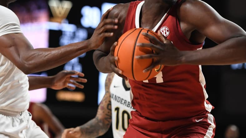 Jan 17, 2023; Nashville, Tennessee, USA; Alabama Crimson Tide center Charles Bediako (14) attempts a shot against Vanderbilt Commodores forward Lee Dort (left) during the second half at Memorial Gymnasium. Mandatory Credit: Christopher Hanewinckel-USA TODAY Sports