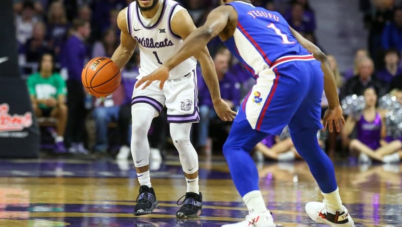 Jan 17, 2023; Manhattan, Kansas, USA; Kansas State Wildcats guard Markquis Nowell (1) brings the ball up court against Kansas Jayhawks guard Joseph Yesufu (1) during the first half at Bramlage Coliseum. Mandatory Credit: Scott Sewell-USA TODAY Sports