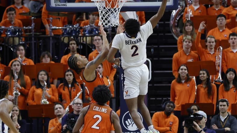 Jan 18, 2023; Charlottesville, Virginia, USA; Virginia Cavaliers guard Reece Beekman (2) dunks the ball as Virginia Tech Hokies center Lynn Kidd (15) defends in the first half at John Paul Jones Arena. Mandatory Credit: Geoff Burke-USA TODAY Sports
