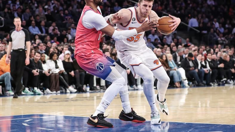 Jan 18, 2023; New York, New York, USA; New York Knicks center Isaiah Hartenstein (55) looks to post up against Washington Wizards forward Taj Gibson (67) in the second quarter at Madison Square Garden. Mandatory Credit: Wendell Cruz-USA TODAY Sports