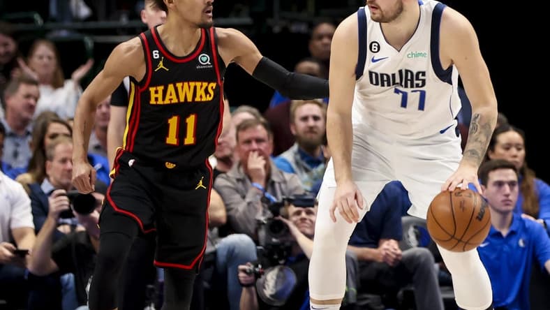 Jan 18, 2023; Dallas, Texas, USA; Dallas Mavericks guard Luka Doncic (77) controls the ball as Atlanta Hawks guard Trae Young (11) defends during the second quarter at American Airlines Center. Mandatory Credit: Kevin Jairaj-USA TODAY Sports