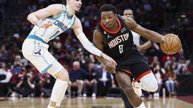 Jan 18, 2023; Houston, Texas, USA;  Houston Rockets forward Jae'Sean Tate (8) drives with the ball as Charlotte Hornets guard LaMelo Ball (1) defends during the second quarter at Toyota Center. Mandatory Credit: Troy Taormina-USA TODAY Sports