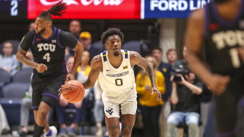 Jan 18, 2023; Morgantown, West Virginia, USA; West Virginia Mountaineers guard Kedrian Johnson (0) dribbles up the court during the second half against the TCU Horned Frogs at WVU Coliseum. Mandatory Credit: Ben Queen-USA TODAY Sports