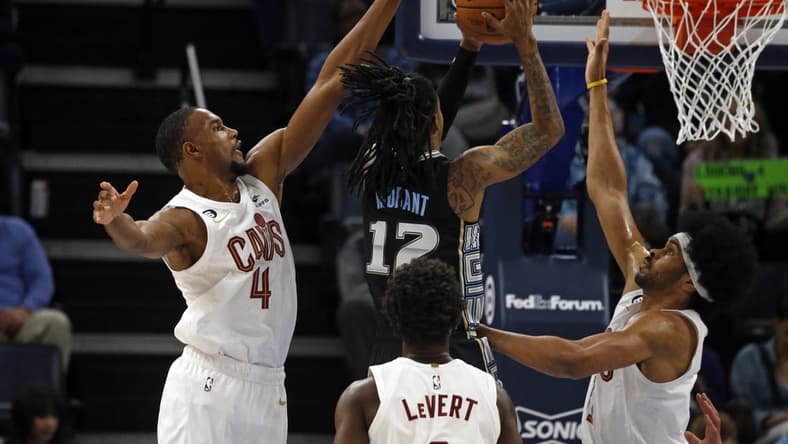 Jan 18, 2023; Memphis, Tennessee, USA; Cleveland Cavaliers forward Evan Mobley (4) and Cleveland Cavaliers center Jarrett Allen (31) defend as Memphis Grizzlies guard Ja Morant (12) drives to the basket during the first half at FedExForum. Mandatory Credit: Petre Thomas-USA TODAY Sports