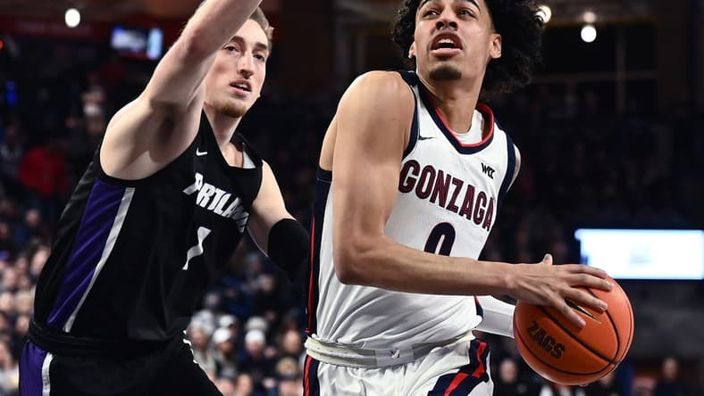 Jan 14, 2023; Spokane, Washington, USA; Gonzaga Bulldogs guard Julian Strawther (0) shoots the ball against Portland Pilots forward Moses Wood (1) in the first half at McCarthey Athletic Center. Mandatory Credit: James Snook-USA TODAY Sports