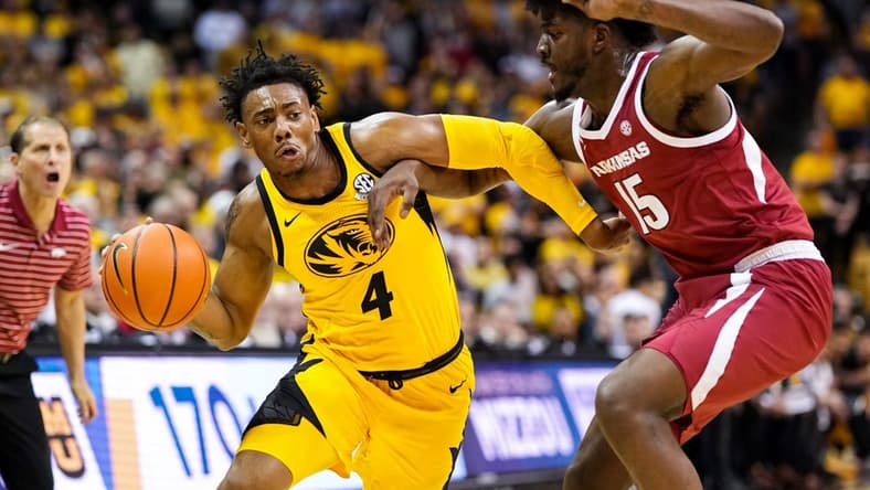 Jan 18, 2023; Columbia, Missouri, USA; Missouri Tigers guard DeAndre Gholston (4) drives against Arkansas Razorbacks forward Makhi Mitchell (15) during the first half at Mizzou Arena. Mandatory Credit: Jay Biggerstaff-USA TODAY Sports