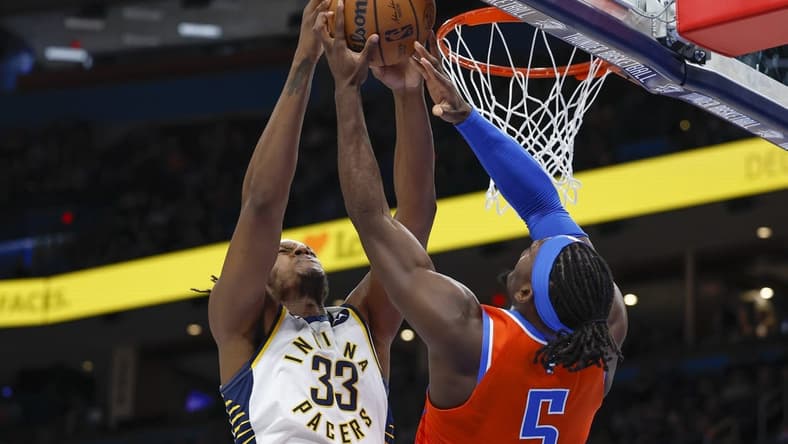 Jan 18, 2023; Oklahoma City, Oklahoma, USA; Indiana Pacers center Myles Turner (33) and Oklahoma City Thunder guard Luguentz Dort (5) fight for a rebound during the second quarter at Paycom Center. Mandatory Credit: Alonzo Adams-USA TODAY Sports