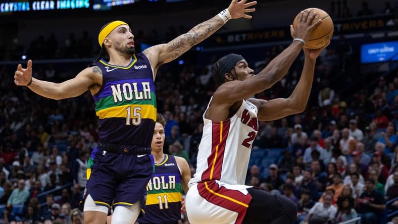 Jan 18, 2023; New Orleans, Louisiana, USA; Miami Heat forward Jimmy Butler (22) drives to the basket against New Orleans Pelicans guard Jose Alvarado (15) during the first half at Smoothie King Center. Mandatory Credit: Stephen Lew-USA TODAY Sports