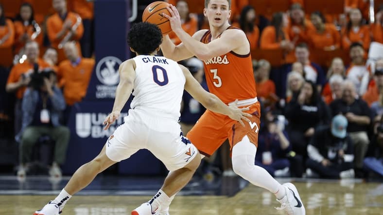 Jan 18, 2023; Charlottesville, Virginia, USA; Virginia Tech Hokies guard Sean Pedulla (3) holds the ball as Virginia Cavaliers guard Kihei Clark (0) defends in the first half at John Paul Jones Arena. Mandatory Credit: Geoff Burke-USA TODAY Sports