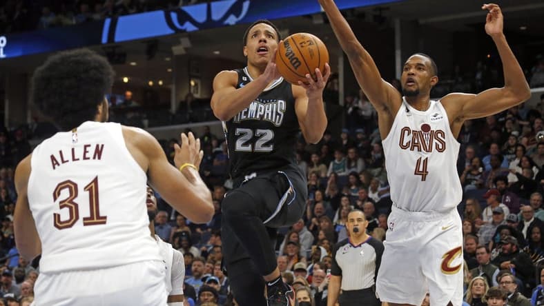 Jan 18, 2023; Memphis, Tennessee, USA; Memphis Grizzlies guard Desmond Bane (22) drives to the basket as Cleveland Cavaliers center Jarrett Allen (31) and forward Evan Mobley (4) defend during the second half at FedExForum. Mandatory Credit: Petre Thomas-USA TODAY Sports