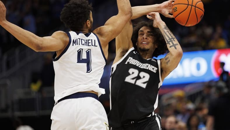 Jan 18, 2023; Milwaukee, Wisconsin, USA; Providence Friars guard Devin Carter (22) loses the ball under pressure from Marquette Golden Eagles guard Stevie Mitchell (4) during the first half at Fiserv Forum. Mandatory Credit: Jeff Hanisch-USA TODAY Sports