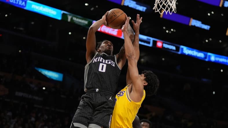Jan 18, 2023; Los Angeles, California, USA; Sacramento Kings guard Malik Monk (0) shoots the ball against Los Angeles Lakers guard Max Christie (10) in the first half at Crypto.com Arena. Mandatory Credit: Kirby Lee-USA TODAY Sports