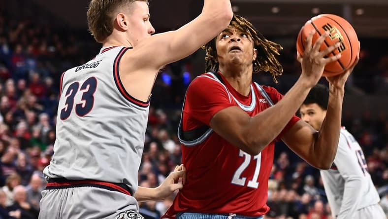 Jan 19, 2023; Spokane, Washington, USA; Loyola Marymount Lions forward Michael Graham (21) shoots the ball against Gonzaga Bulldogs forward Ben Gregg (33) in the first half at McCarthey Athletic Center. Mandatory Credit: James Snook-USA TODAY Sports