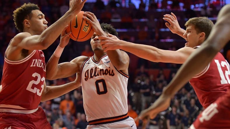 Jan 19, 2023; Champaign, Illinois, USA;  Indiana Hoosiers forward Trayce Jackson-Davis (23) and Miller Kopp (12) defend against  Illinois Fighting Illini guard Terrence Shannon Jr. (0) during the first half at State Farm Center. Mandatory Credit: Ron Johnson-USA TODAY Sports