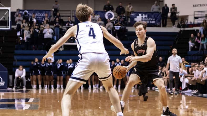 Jan 19, 2023; West Long Branch, New Jersey, USA; Charleston Cougars guard Reyne Smith (2) sets the play as Monmouth Hawks guard Andrew Ball (4) defends during the first half at OceanFirst Bank Center. Mandatory Credit: John Jones-USA TODAY Sports