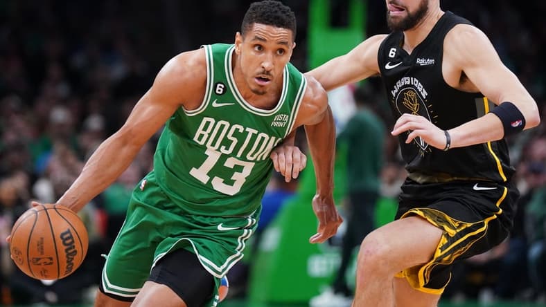 Jan 19, 2023; Boston, Massachusetts, USA; Boston Celtics guard Malcolm Brogdon (13) drive the ball against Golden State Warriors guard Klay Thompson (11) in the second half at TD Garden. Mandatory Credit: David Butler II-USA TODAY Sports