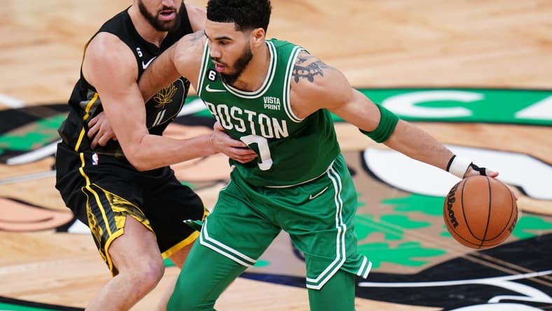 Jan 19, 2023; Boston, Massachusetts, USA; Boston Celtics forward Jayson Tatum (0) dribbles the ball against Golden State Warriors guard Klay Thompson (11) in the second quarter at TD Garden. Mandatory Credit: David Butler II-USA TODAY Sports