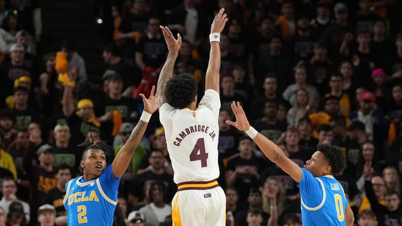 Jan 19, 2023; Tempe, Arizona, USA; Arizona State Sun Devils guard Desmond Cambridge Jr. (4) shoots over UCLA Bruins guard Dylan Andrews (2) and UCLA Bruins guard Jaylen Clark (0) during the first half at Desert Financial Arena. Mandatory Credit: Joe Camporeale-USA TODAY Sports
