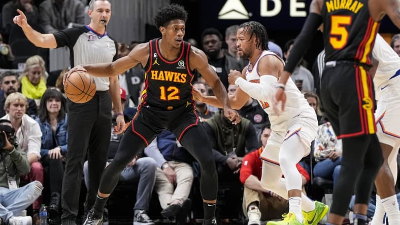 Jan 20, 2023; Atlanta, Georgia, USA; Atlanta Hawks forward De'Andre Hunter (12) dribbles against New York Knicks guard Jalen Brunson (11) during the first half at State Farm Arena. Mandatory Credit: Dale Zanine-USA TODAY Sports