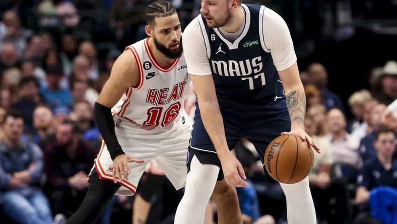 Jan 20, 2023; Dallas, Texas, USA;  Dallas Mavericks guard Luka Doncic (77) controls the ball as Miami Heat forward Caleb Martin (16) defends during the second quarter at American Airlines Center. Mandatory Credit: Kevin Jairaj-USA TODAY Sports