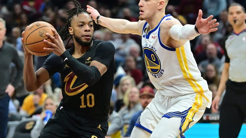 Jan 20, 2023; Cleveland, Ohio, USA; Cleveland Cavaliers guard Darius Garland (10) drives to the basket against Golden State Warriors guard Donte DiVincenzo (0) during the second half at Rocket Mortgage FieldHouse. Mandatory Credit: Ken Blaze-USA TODAY Sports