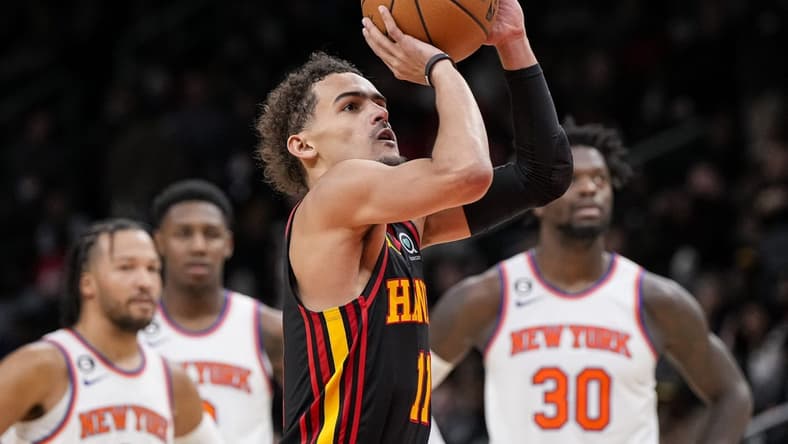 Jan 20, 2023; Atlanta, Georgia, USA; Atlanta Hawks guard Trae Young (11) shoots a foul shot watched by New York Knicks players after a technical foul call during the second half at State Farm Arena. Mandatory Credit: Dale Zanine-USA TODAY Sports