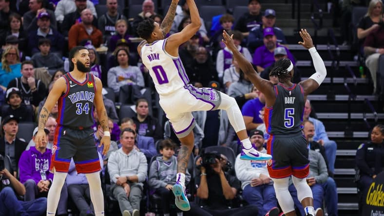 Jan 20, 2023; Sacramento, California, USA; Sacramento Kings guard Malik Monk (0) shoots the ball against Oklahoma City Thunder guard Luguentz Dort (5) during the second quarter at Golden 1 Center. Mandatory Credit: Sergio Estrada-USA TODAY Sports