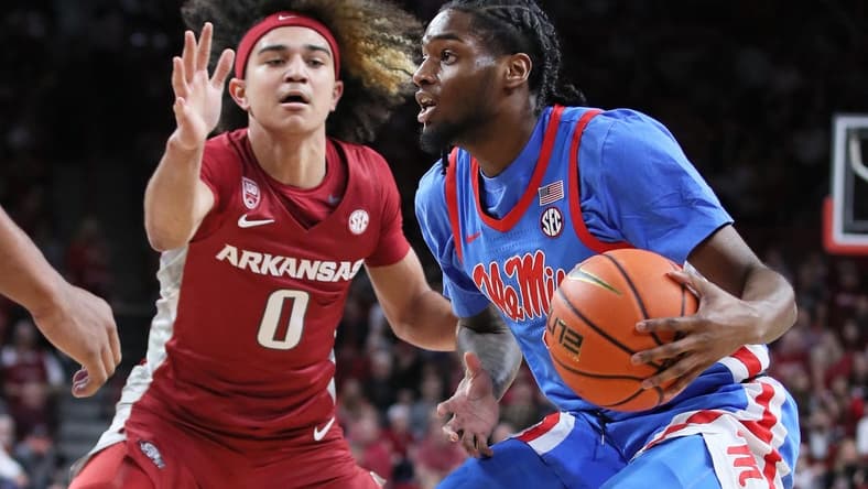 Jan 21, 2023; Fayetteville, Arkansas, USA; Ole Miss Rebels guard Amaree Abram (1) drives against Arkansas Razorbacks guard Anthony Black (0) during the first half at Bud Walton Arena. Mandatory Credit: Nelson Chenault-USA TODAY Sports