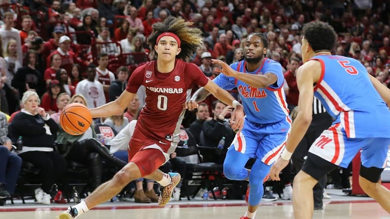 Jan 21, 2023; Fayetteville, Arkansas, USA; Arkansas Razorbacks guard Anthony Black (0) drives against Ole Miss Rebels guard Amaree Abram (1) during the second half at Bud Walton Arena. Arkansas won 69-57. Mandatory Credit: Nelson Chenault-USA TODAY Sports