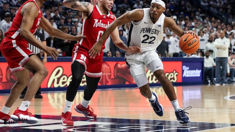 Jan 21, 2023; University Park, Pennsylvania, USA; Penn State Nittany Lions guard Jalen Pickett (22) dribbles the ball around Nebraska Cornhuskers guard CJ Wilcher (0) during the first half at Bryce Jordan Center. Mandatory Credit: Matthew OHaren-USA TODAY Sports
