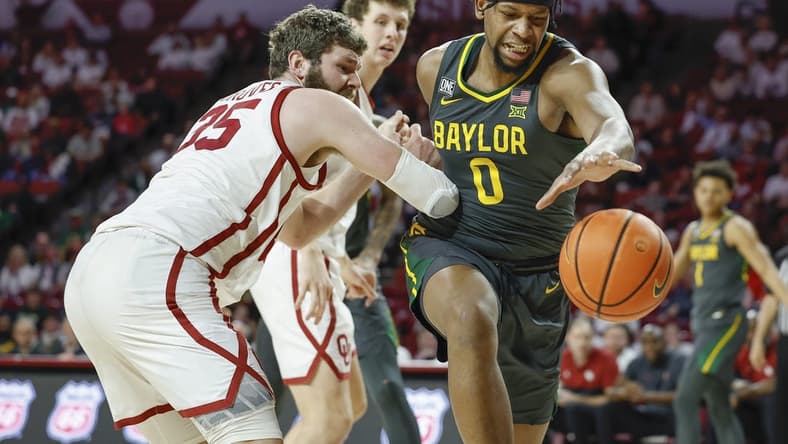 Jan 21, 2023; Norman, Oklahoma, USA; Baylor Bears forward Flo Thamba (0) reaches for a loose ball as Oklahoma Sooners forward Tanner Groves (35) defends during the first half at Lloyd Noble Center. Mandatory Credit: Alonzo Adams-USA TODAY Sports