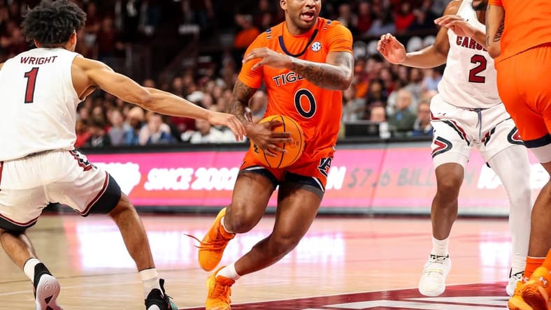 Jan 21, 2023; Columbia, South Carolina, USA; Auburn Tigers guard K.D. Johnson (0) drives past South Carolina Gamecocks guard Jacobi Wright (1) in the first half at Colonial Life Arena. Mandatory Credit: Jeff Blake-USA TODAY Sports