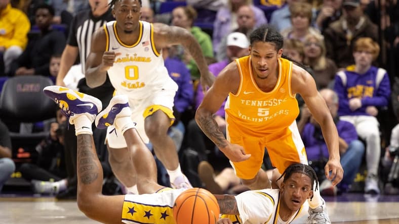 Jan 21, 2023; Baton Rouge, Louisiana, USA; LSU Tigers forward Derek Fountain (20) knocks the ball away from Tennessee Volunteers guard Zakai Zeigler (5) during the first half at Pete Maravich Assembly Center. Mandatory Credit: Stephen Lew-USA TODAY Sports