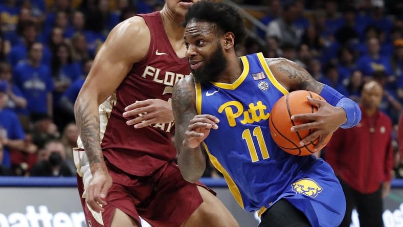 Jan 21, 2023; Pittsburgh, Pennsylvania, USA;  Pittsburgh Panthers guard Jamarius Burton (11) drives to the basket against Florida State Seminoles forward Cam Corhen (3) during the second half at the Petersen Events Center. The Seminoles won 71-64. Mandatory Credit: Charles LeClaire-USA TODAY Sports