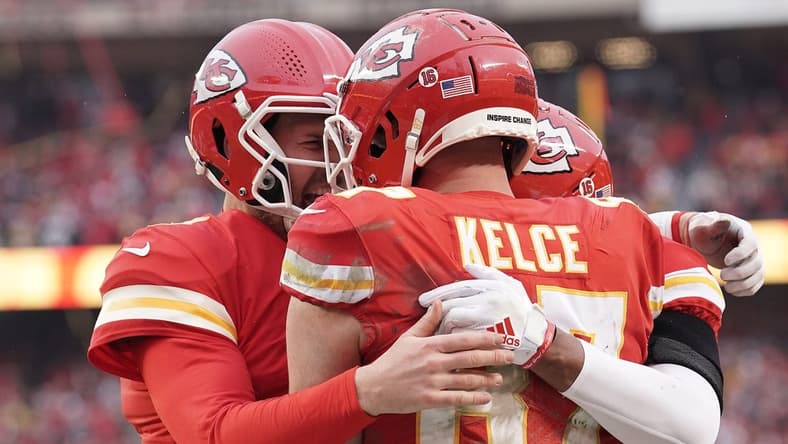 Jan 21, 2023; Kansas City, Missouri, USA; Kansas City Chiefs tight end Travis Kelce (87) celebrates his touchdown scored against the Jacksonville Jaguars with quarterback Chad Henne (4) during the first half in the AFC divisional round game at GEHA Field at Arrowhead Stadium. Mandatory Credit: Denny Medley-USA TODAY Sports