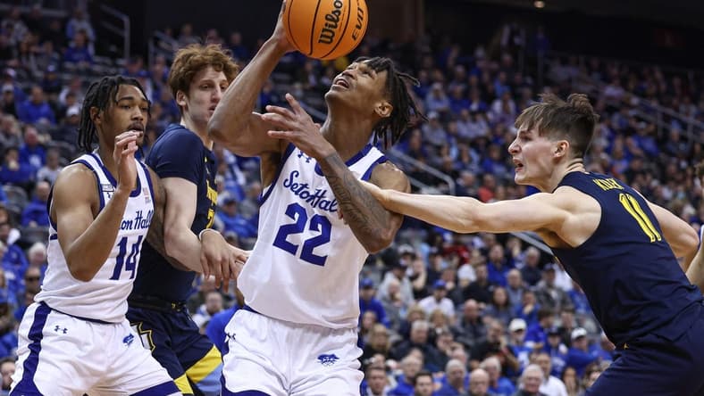 Jan 21, 2023; Newark, New Jersey, USA; Seton Hall Pirates forward Tae Davis (22) is fouled by Marquette Golden Eagles guard Tyler Kolek (11) in front of forward Ben Gold (21) and guard Dre Davis (14) during the second half at Prudential Center. Mandatory Credit: Vincent Carchietta-USA TODAY Sports