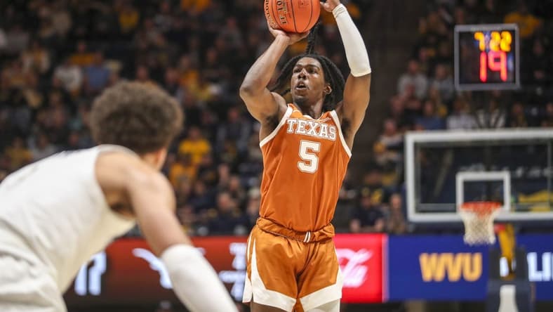 Jan 21, 2023; Morgantown, West Virginia, USA; Texas Longhorns guard Marcus Carr (5) shoots a three pointer during the first half against the West Virginia Mountaineers at WVU Coliseum. Mandatory Credit: Ben Queen-USA TODAY Sports