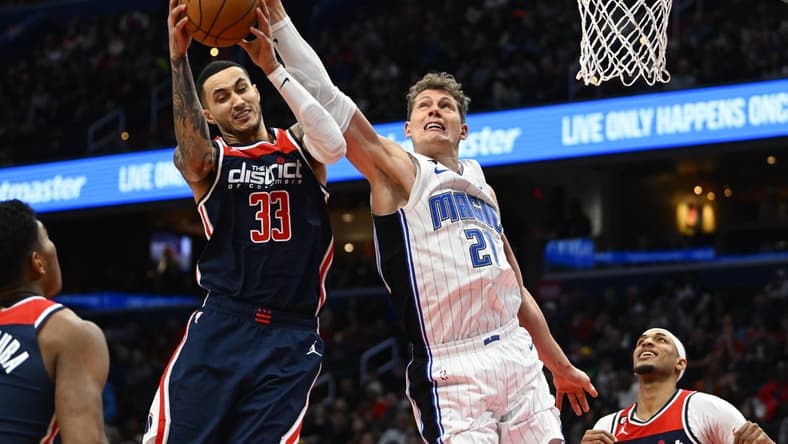 Jan 21, 2023; Washington, District of Columbia, USA; Washington Wizards forward Kyle Kuzma (33) grabs a rebound over Orlando Magic center Moritz Wagner (21) during the first half at Capital One Arena. Mandatory Credit: Brad Mills-USA TODAY Sports