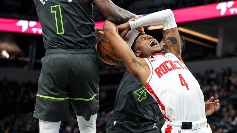 Jan 21, 2023; Minneapolis, Minnesota, USA; Houston Rockets guard Jalen Green (4) is blocked by Minnesota Timberwolves guard Anthony Edwards (1) and guard Jaylen Nowell (4) during the second quarter at Target Center. Mandatory Credit: Brace Hemmelgarn-USA TODAY Sports