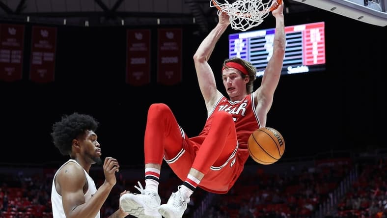Jan 21, 2023; Salt Lake City, Utah, USA; Utah Utes center Branden Carlson (right) dunks against Washington Huskies forward Keion Brooks (left) in the second half at Jon M. Huntsman Center. Mandatory Credit: Rob Gray-USA TODAY Sports
