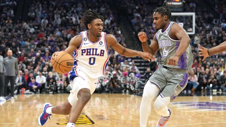 Jan 21, 2023; Sacramento, California, USA; Philadelphia 76ers guard Tyrese Maxey (0) dribbles against Sacramento Kings guard Davion Mitchell (15) during the first quarter at Golden 1 Center. Mandatory Credit: Darren Yamashita-USA TODAY Sports
