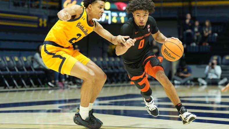 Jan 22, 2023; Berkeley, California, USA; Oregon State Beavers guard Jordan Pope (0) dribbles against California Golden Bears forward Monty Bowser (2) during the first half at Haas Pavilion. Mandatory Credit: Darren Yamashita-USA TODAY Sports