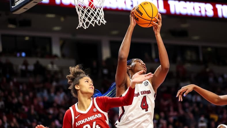 Jan 22, 2023; Columbia, South Carolina, USA; South Carolina Gamecocks forward Aliyah Boston (4) grabs a rebound over Arkansas Razorbacks guard Jersey Wolfenbarger (24) in the first half at Colonial Life Arena. Mandatory Credit: Jeff Blake-USA TODAY Sports