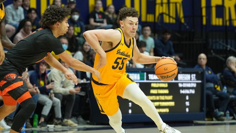 Jan 22, 2023; Berkeley, California, USA; California Golden Bears guard Devin Askew (55) dribbles against Oregon State Beavers guard Jordan Pope (0) during the second half at Haas Pavilion. Mandatory Credit: Darren Yamashita-USA TODAY Sports