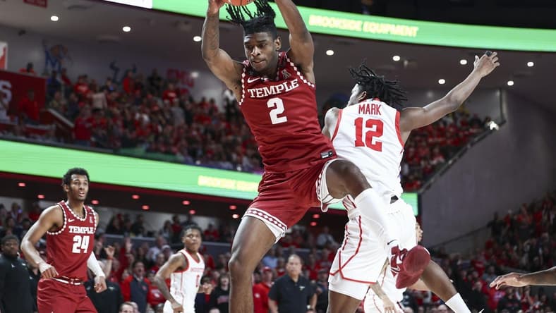 Jan 22, 2023; Houston, Texas, USA; Temple Owls guard Jahlil White (2) grabs a rebound away from Houston Cougars guard Tramon Mark (12) during the second half at Fertitta Center. Mandatory Credit: Troy Taormina-USA TODAY Sports