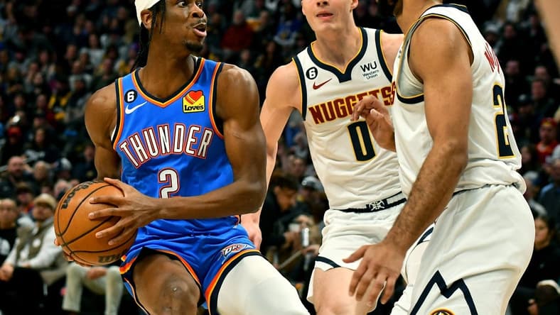 Jan 22, 2023; Denver, Colorado, USA; Oklahoma City Thunder guard Shai Gilgeous-Alexander (2) drives to the basket as Denver Nuggets guard Jamal Murray (27) comes in on defense during the first quarter at Ball Arena. Mandatory Credit: John Leyba-USA TODAY Sports