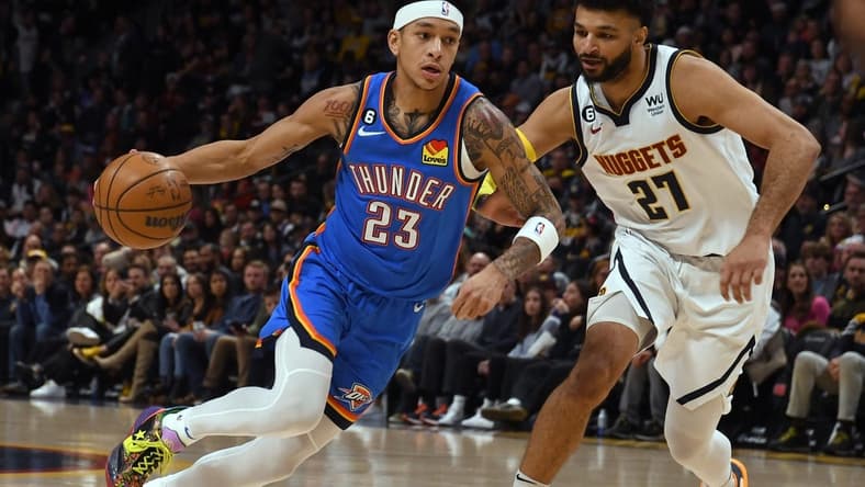 Jan 22, 2023; Denver, Colorado, USA; Oklahoma City Thunder guard Tre Mann (23) drives on Denver Nuggets guard Jamal Murray (27) during the first quarter at Ball Arena. Mandatory Credit: John Leyba-USA TODAY Sports