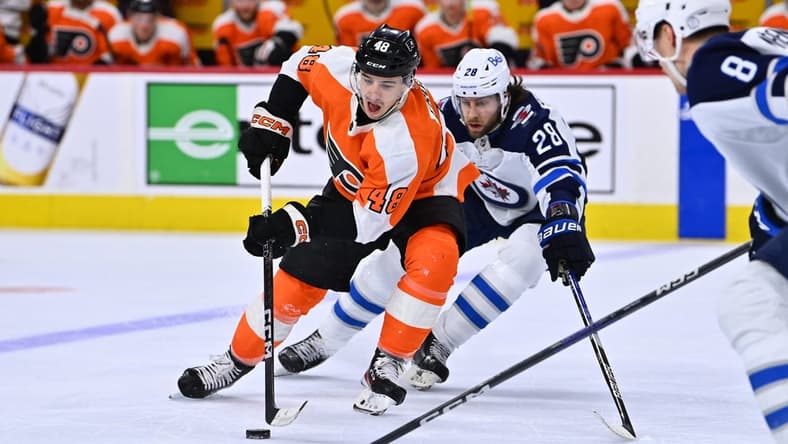 Jan 22, 2023; Philadelphia, Pennsylvania, USA; Philadelphia Flyers center Morgan Frost (48) reaches for the puck against Winnipeg Jets center Kevin Stenlund (28) in the second period at Wells Fargo Center. Mandatory Credit: Kyle Ross-USA TODAY Sports